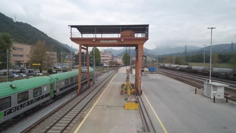 train station aerial footage. passing under a cargo metal structure.