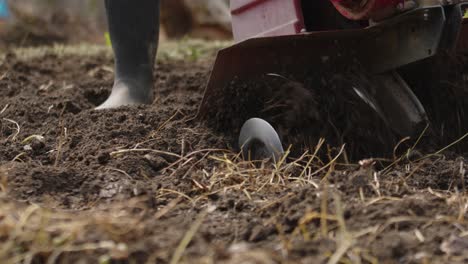 gardener starting tiller machine establishing shot