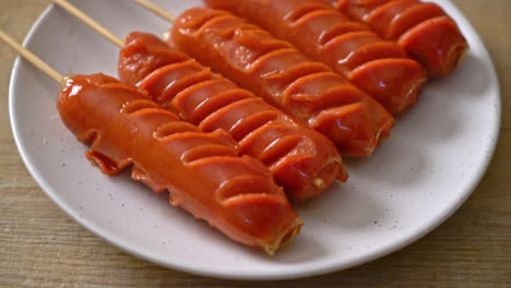 fried sausage skewer on white plate