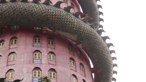 looking-up-at-buddhist-Dragon-Temple,-Wat-Sam-Phran-near-Bangkok-Thailand