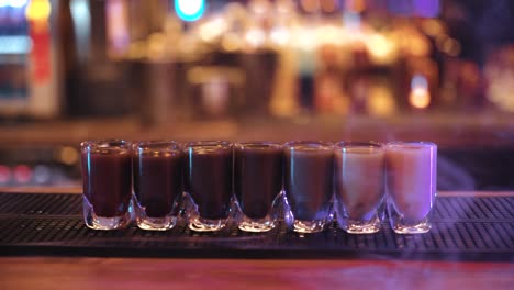 colorful-shot-drinks-with-smoke-on-the-bar-table