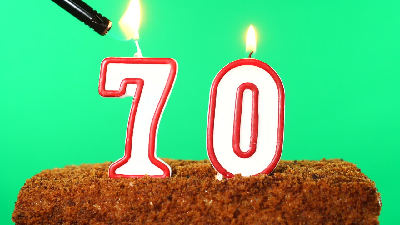 Cake with the number 70 lighted candle. Chroma key. Green Screen. Isolated