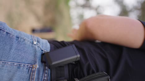 vertical shot of male remove bullet magazine from holder and reload gun