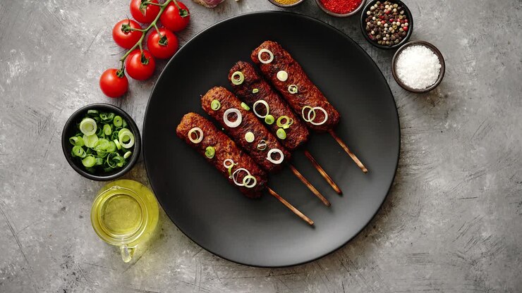 Barbecued turkey kebab decorated with fresh onion