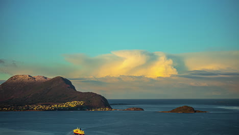 amazing bright dramatic sky in warm colours above alesund valderoya and islands at sunrise in timelapse