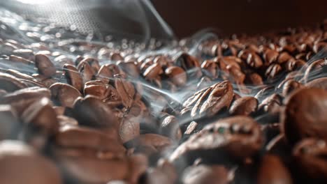 Close-up-of-seeds-of-coffee.-Fragrant-coffee-beans-are-roasted-smoke-comes-from-coffee-beans.