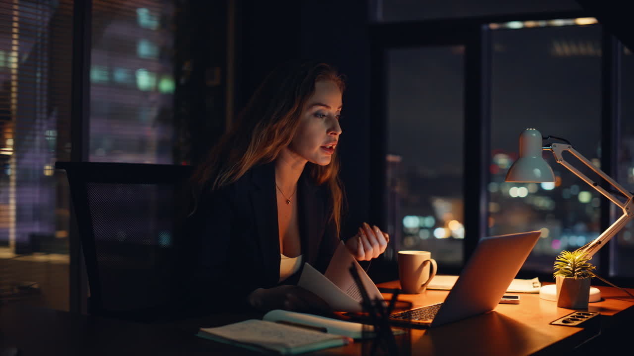 Angry boss shouting online conference call in contemporary night office closeup