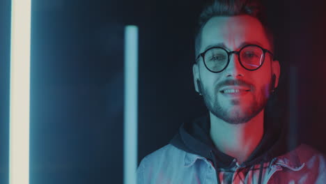 man listening to music in neon light