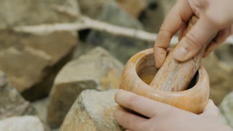 using a stone mortar and pestle