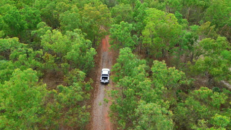 drone areal footage of a utility vehicle driving through a dirt roan in outback australia