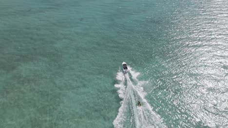 boat taking inflatable towable in ocean in indian ocean, exmouth, western australia