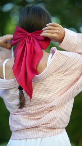 woman with a red bow in her hair