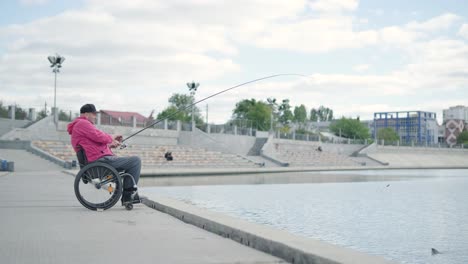 person with a physical disability who uses wheelchair fishing from fishing pier