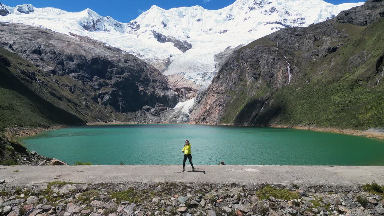 Tourist Latina poses for flyover at stunning mtn landscape, Rajucolta