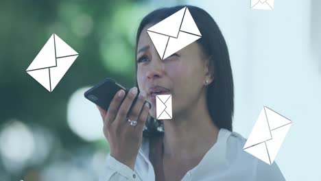 Animation of envelope mail icons falling over woman talking on smartphone