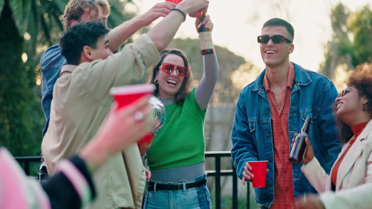 Group of Friends Celebrating Outdoors with Drinks and a Disco Ball