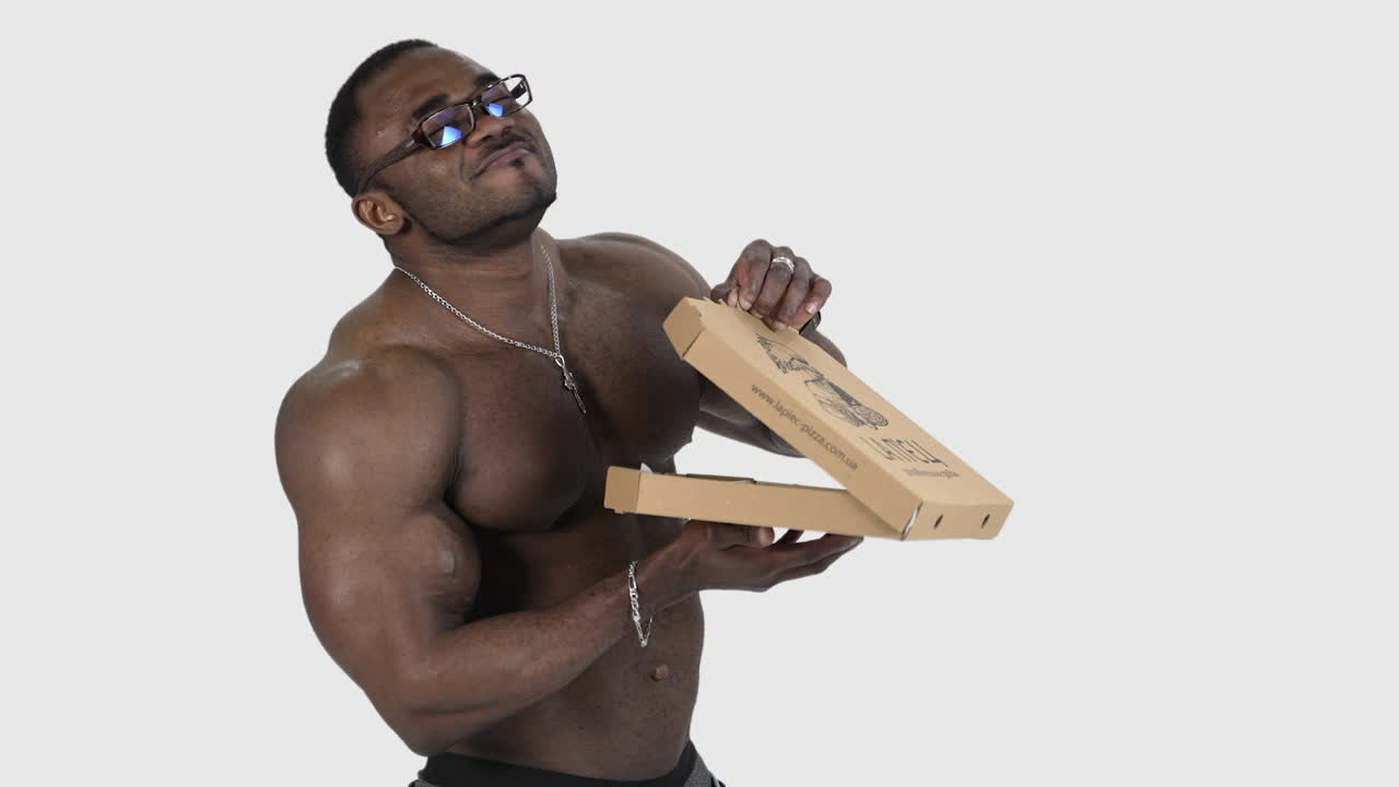 Sportsman with pizza isolated in studio. Fit african man opening box with pizza isolated in studio