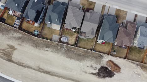 Aerial-view-of-a-modern-suburban-community-in-Calgary,-Canada,-in-spring-after-the-snow-melt