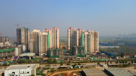 aerial drone shot capturing a massive high rise construction site in noida india