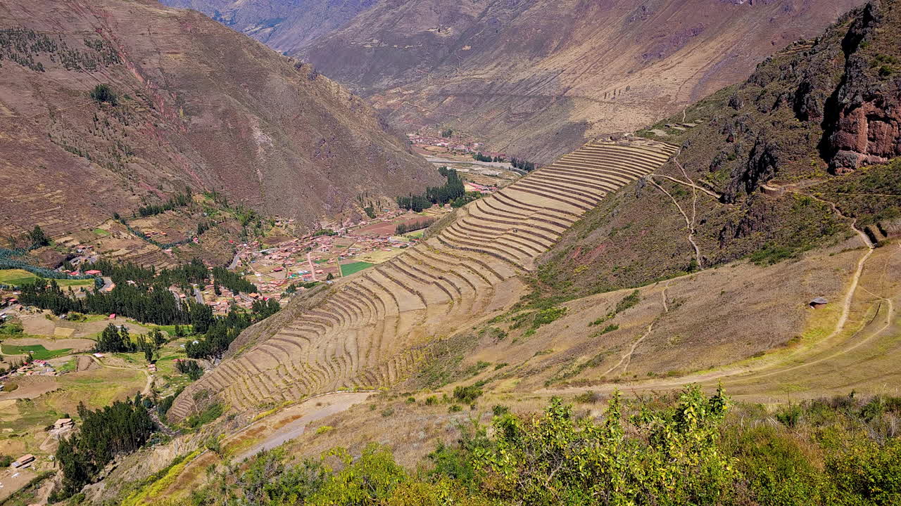 Remarkable agricultural terraces of the Pisac Archaeological Park in Peru. The footage showcases the curved, layered terraces and the stunning natural beauty of the Sacred Valley