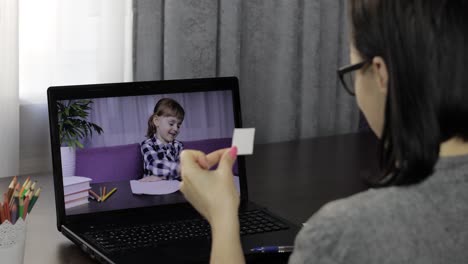 teacher making video call on laptop with pupil. distance children education