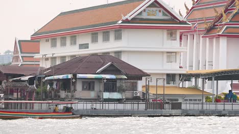 boat travels along chao phraya river in bangkok