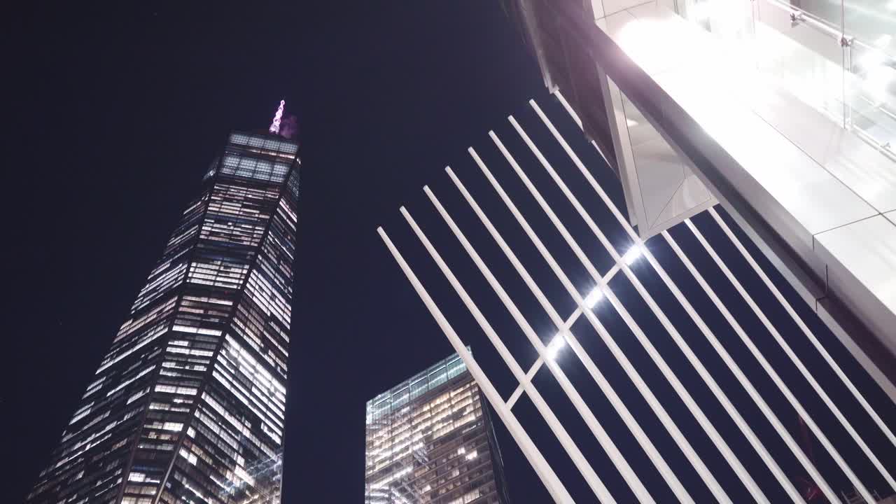 camera looking up to World Trade Centre Oculus and skyscraper One World Trade at night