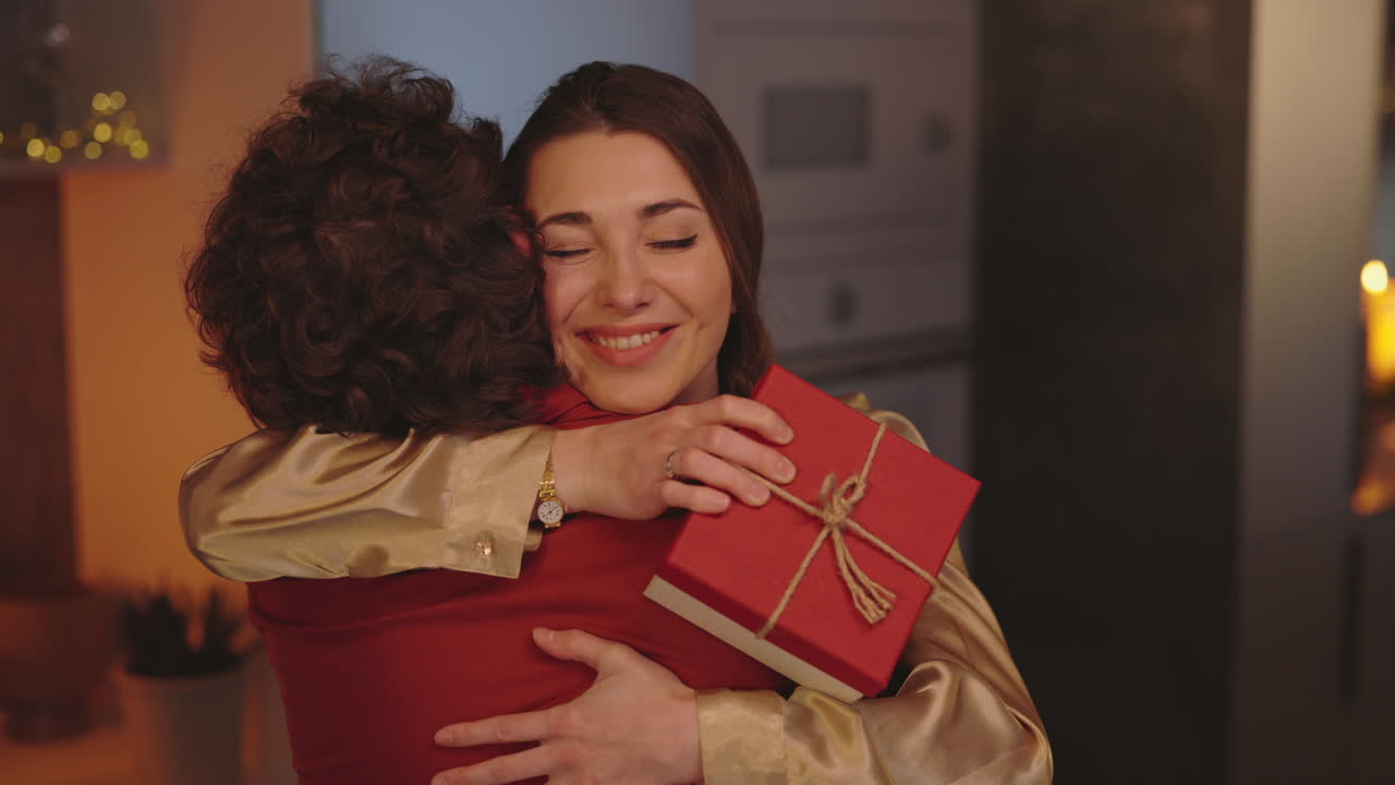 Happy Woman Embracing Partner While Receiving a Gift