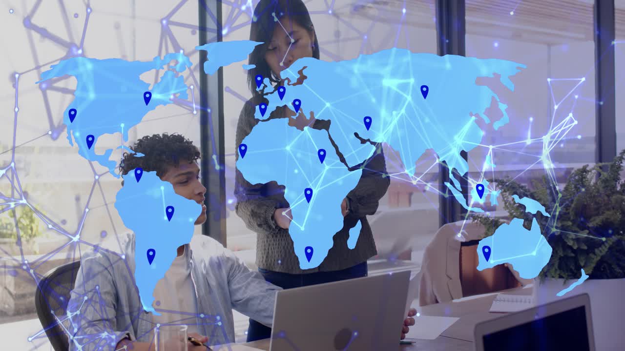 Two colleagues at laptop in tech office, analyzing network data as map overlay sliding over them