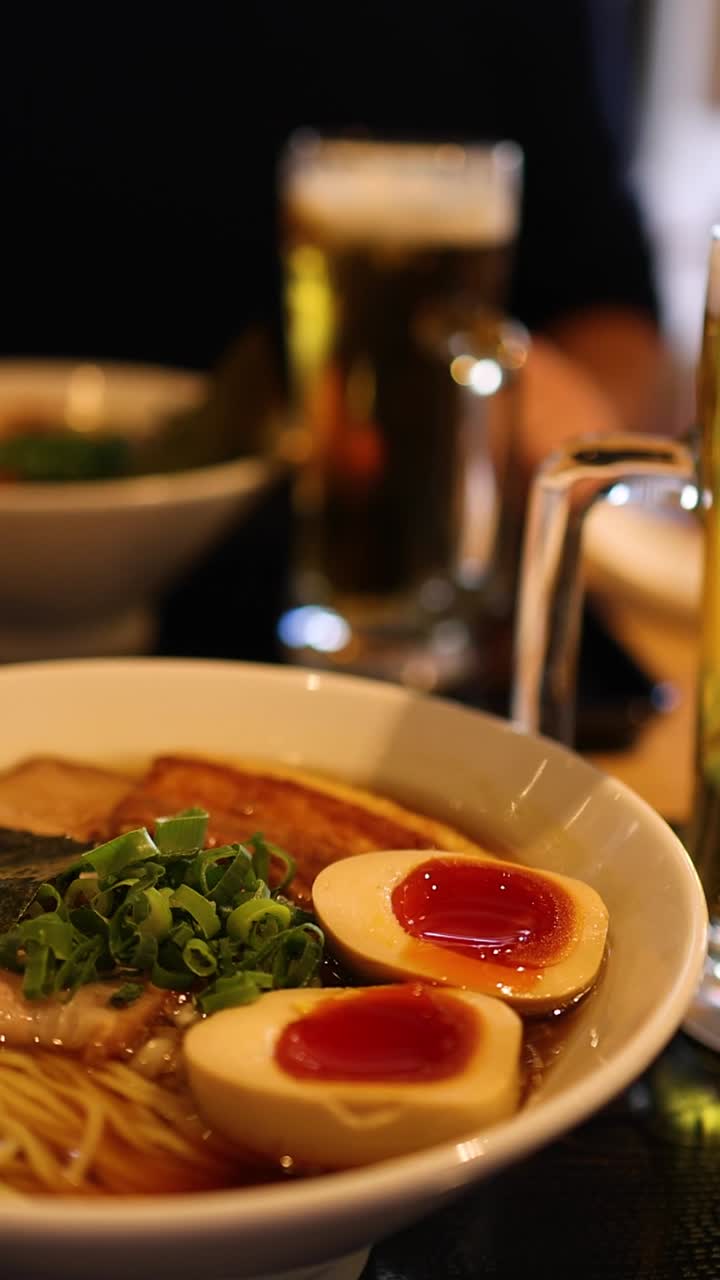 A detailed close-up shot of a savory ramen bowl featuring soft-boiled eggs and scallions