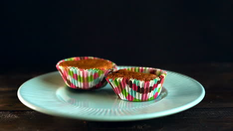 Chef-put-cupcakes-on-ceramic-plate.-Homemade-cupcake.-Muffins-in-paper-tray