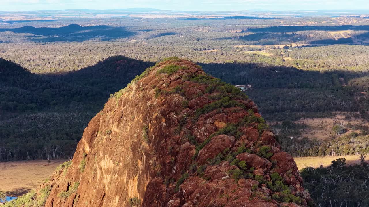 Drone glides over Timor Rock volcanic outcrop, revealing rugged sandstone and sweeping Australian landscape