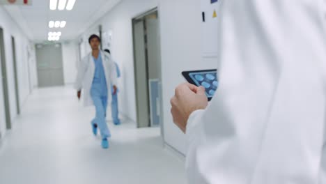 doctor walking in hospital corridor using tablet 4k