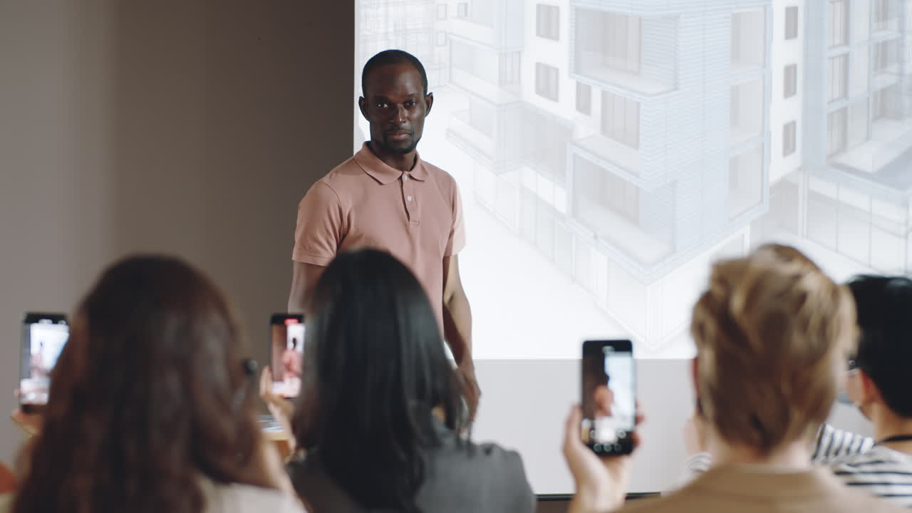 African American Speaker Talking to Audience on Architecture Conference