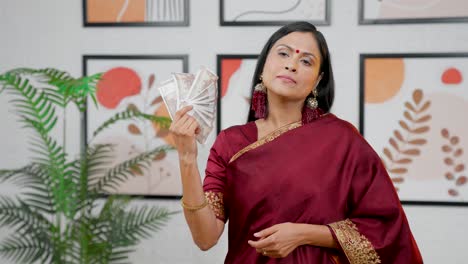 Wealthy-Indian-woman-use-money-as-fan