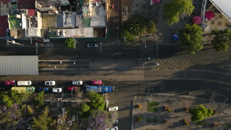 Aerial-overhead-view-hyper-lapse-of-vehicles-in-street-pass-fast-motion-in-Mexico-city-suburbs