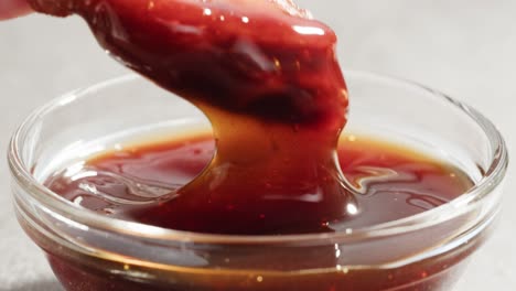 dipping crispy meat in brown sauce