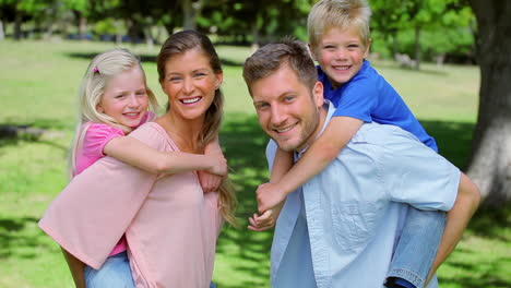 Boy-runs-and-jumps-onto-his-fathers-back-who-gives-him-a-piggyback