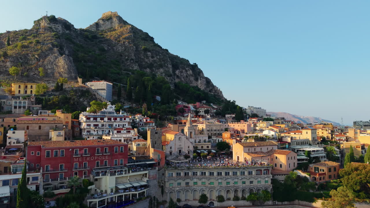 Colorful Italian village of Taormina on a cliff. Aerial view