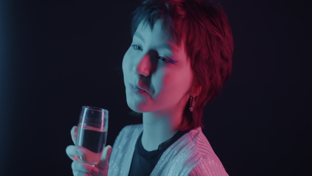 Woman Drinking Champagne in Neon Light