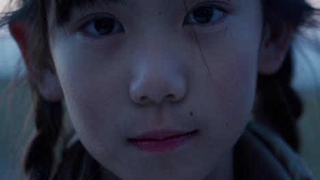 portrait of sad asian japanese girl child outdoors at twilight