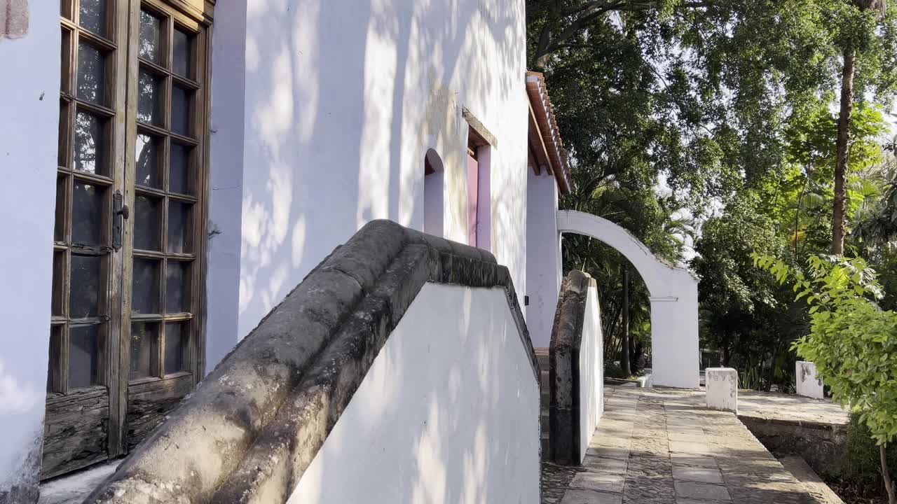 view of the white facades of some mansions with a wonderful orchard in the background in Cuernavaca, Mexico