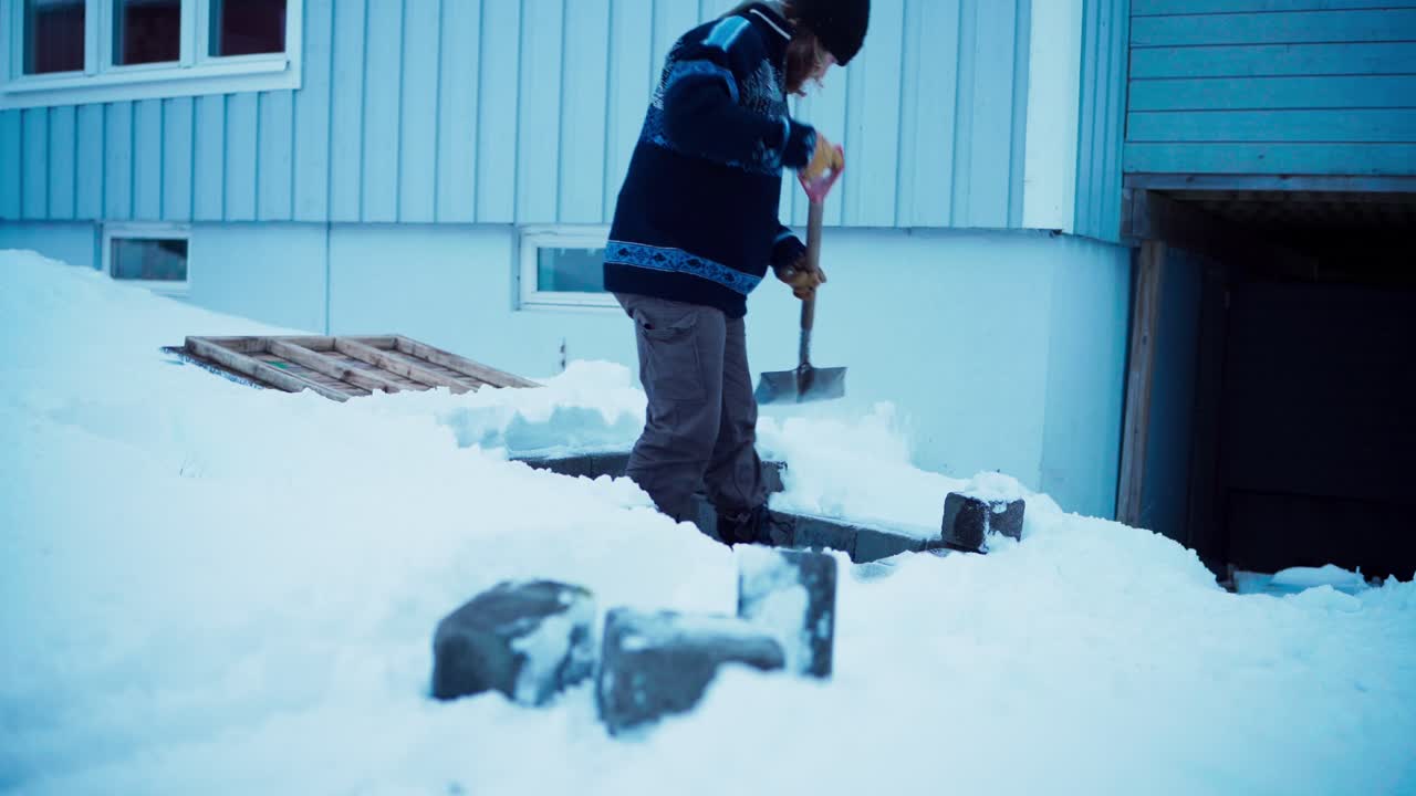 Man Clearing Snow Off With Shovel During Winter - Wide Shot