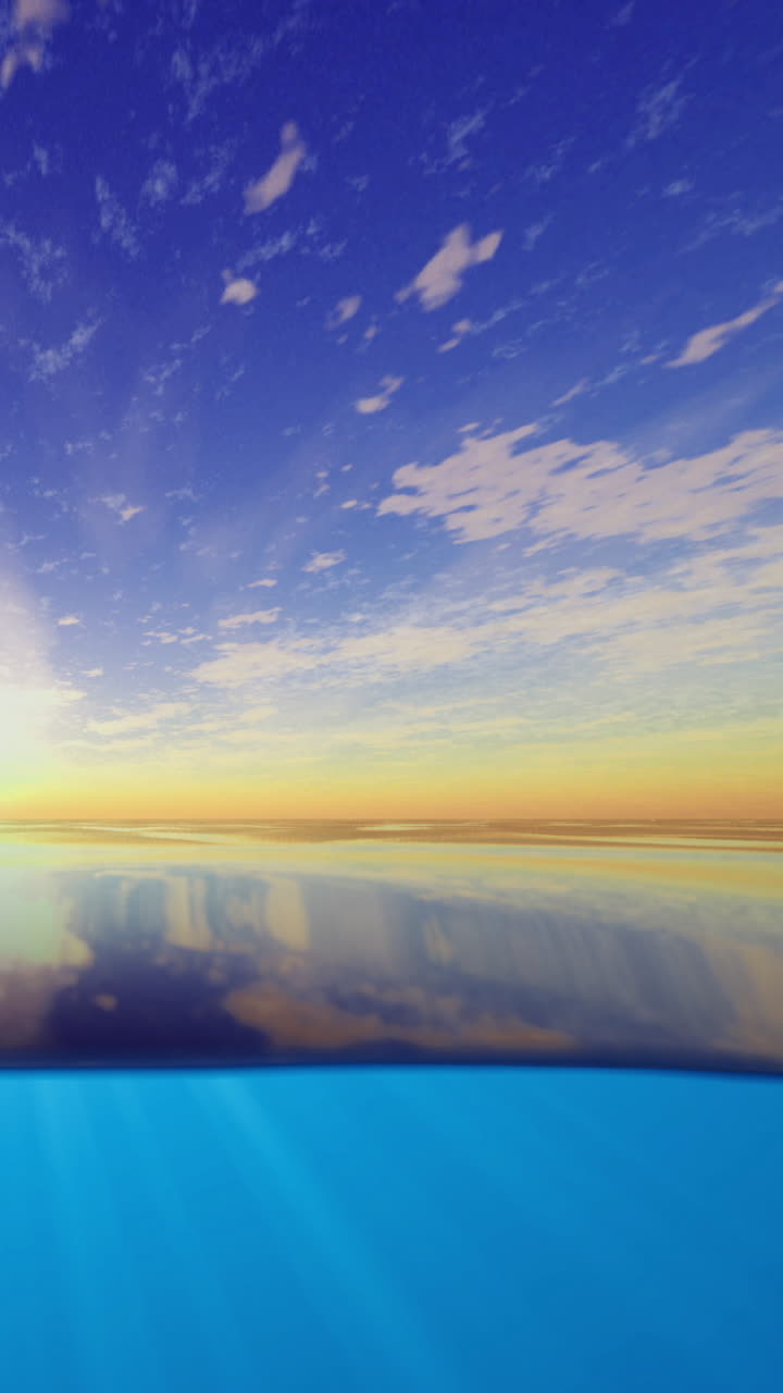 Sky and water reflect colors at sunset near calm ocean surface