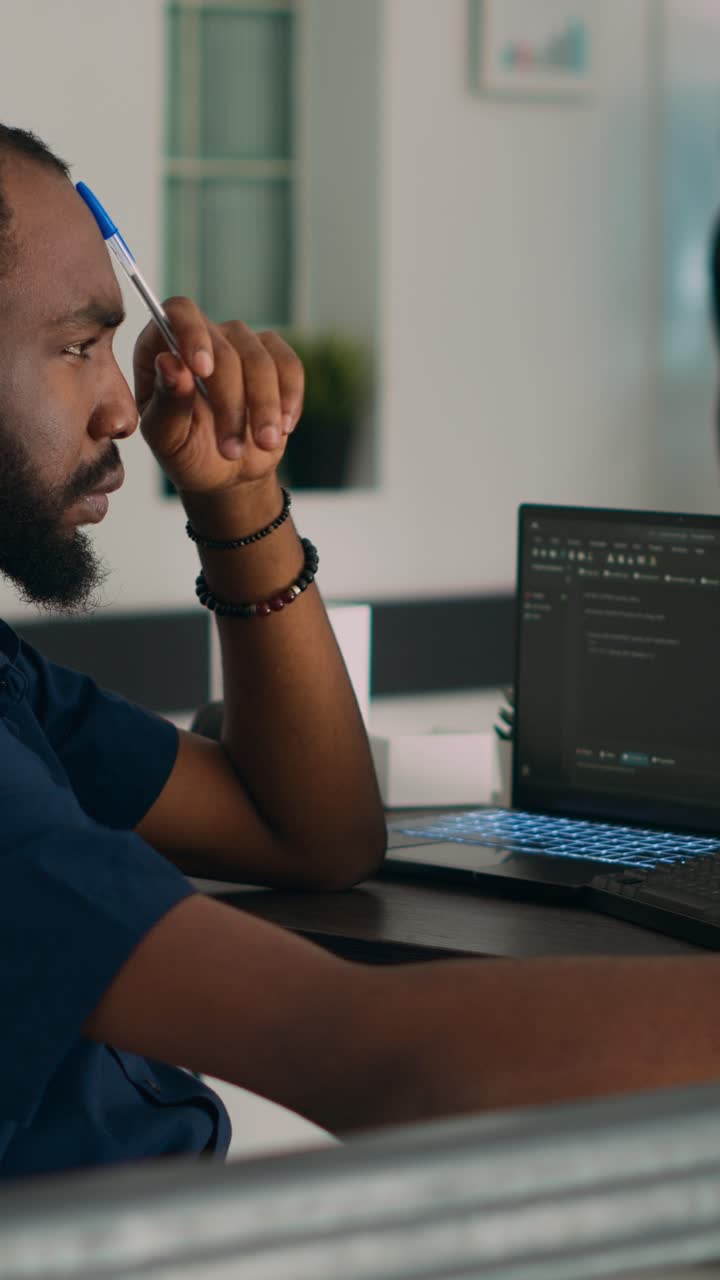 Vertical video: Software developer brainstorming ideas to write code and create new interface