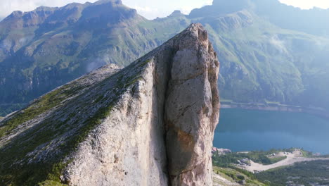 sun shinning on steep mountain cliff face in italian dolomite on sunny summer day, aerial