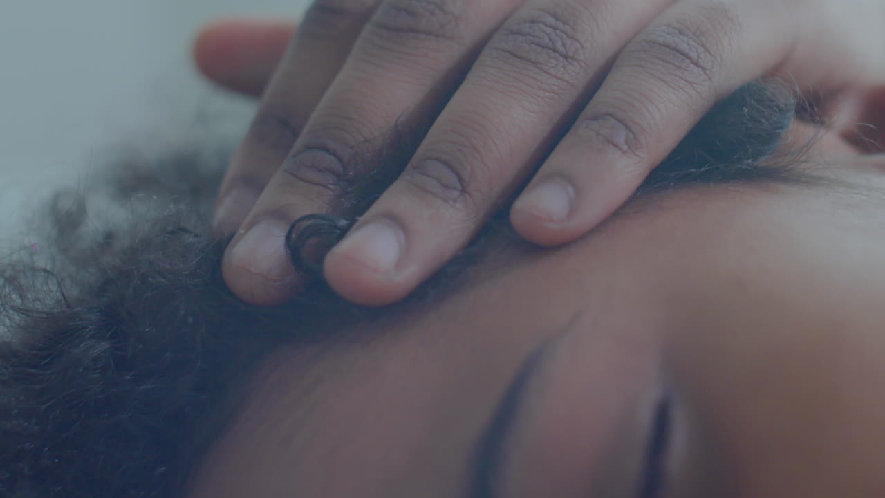 African American Mom Cuddling Sleeping Kid