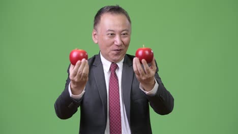 mature japanese businessman with apples