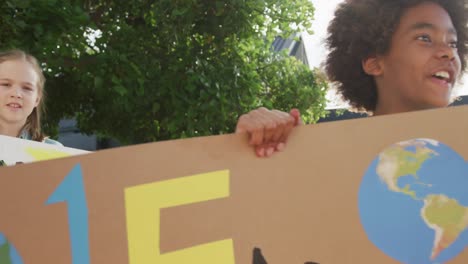 video of diverse schoolchildren holding protest placards and chanting outdoors, copy space