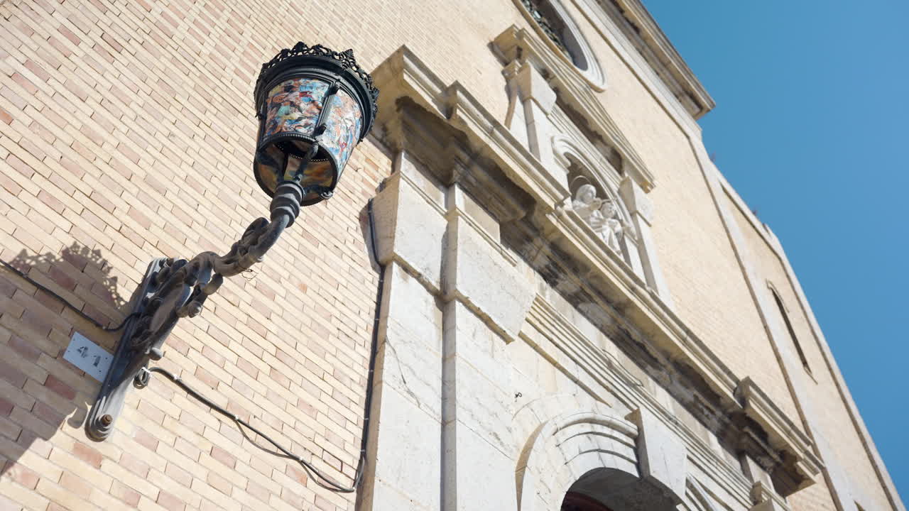 Ornate Street Lamp on a Church Facade